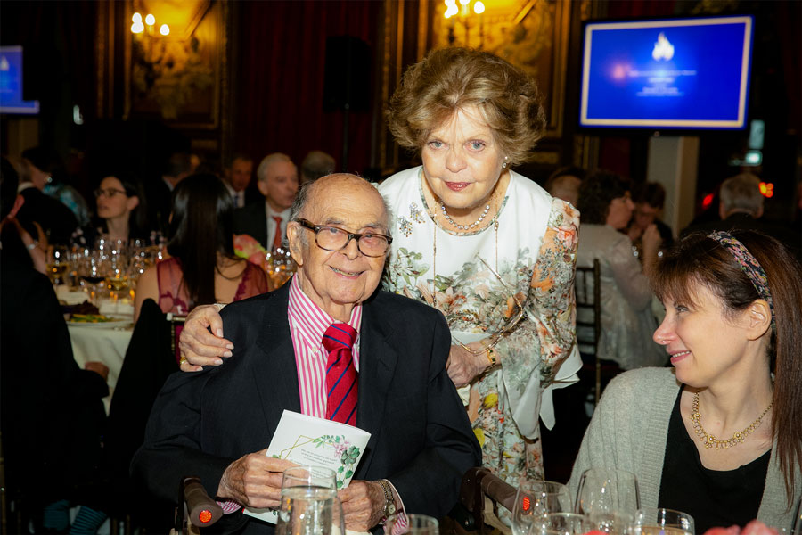 Dr. Legato with her arm on the shoulder of a guest during the 2019 Gala