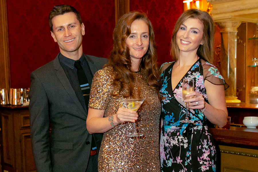 Three people smile and pose for a picture at the Gala