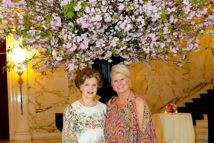 Dr. Legato and woman smiling under floral centerpiece