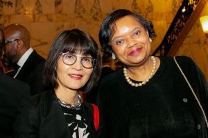 Two women facing the camera and smiling at Gala