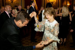 Dr. Legato dancing and smiling with a male guest during the 2019 Gala