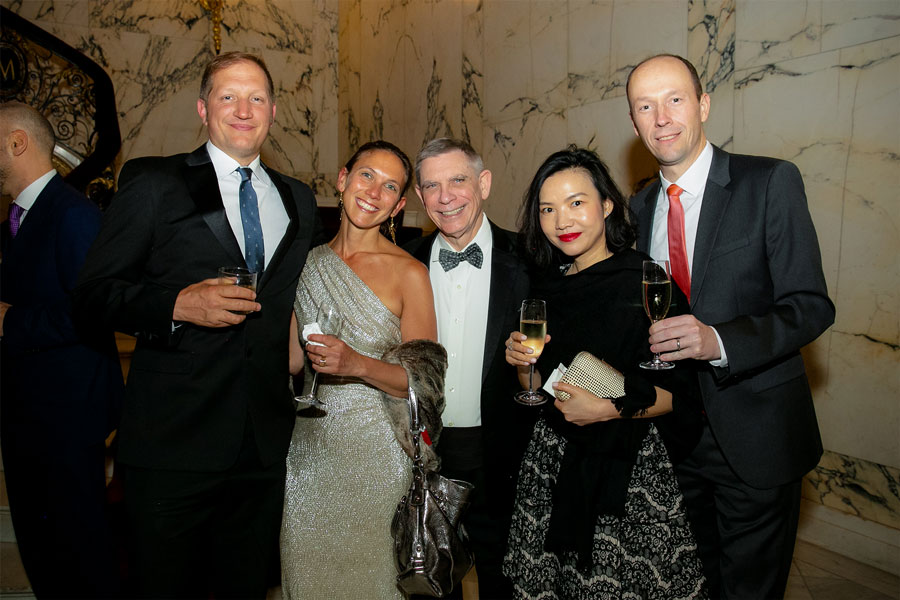 Five people stand and pose for the camera at the 2019 Gala